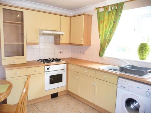 a kitchen with a sink and a stove top oven at 2 Bed Semi - Sleeps 4 - Private Garden & Parking - Quiet Cul De Sac Location - Dog Friendly - Fast Wifi - Close to Motorway Access in Doncaster