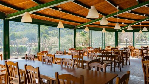 a dining room with tables and chairs and windows at Centro Turistico San Nicola in Peschici