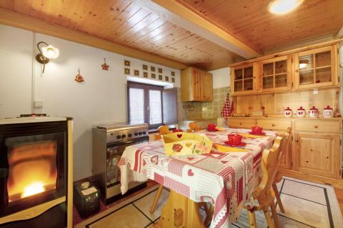 a kitchen with a table and a stove and a table sidx sidx sidx at Petite Maison des Alpes in Morgex