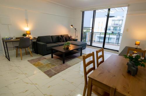 a living room with a couch and a table at 2Bedrooms, 2-bath, 1 Garage Apartment in Sydney