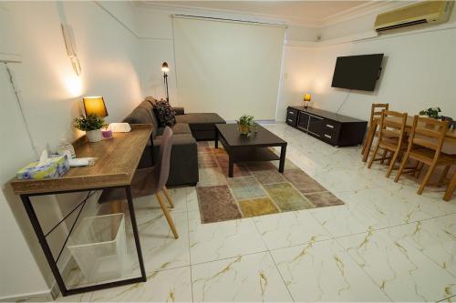 a living room with a couch and a tv at 2Bedrooms, 2-bath, 1 Garage Apartment in Sydney