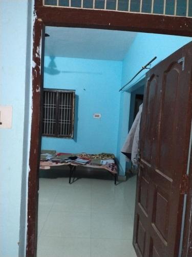 a room with a room with a bed and a door at Pathak,s home in Ayodhya