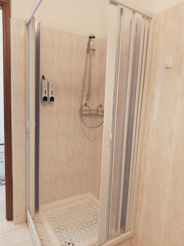 a shower with a glass door in a bathroom at La casa di Lilly in Civitavecchia