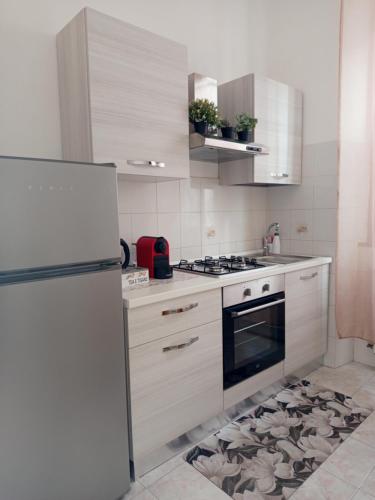 a kitchen with a refrigerator and a stove top oven at La casa di Lilly in Civitavecchia