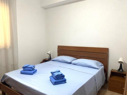 a bedroom with a bed with blue towels on it at Appartamento Il Corallo Blu in Lampedusa