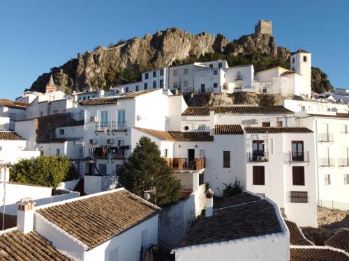 a cluster of white houses in front of a mountain w obiekcie Mirador del farmacéutico w mieście Zahara de la Sierra