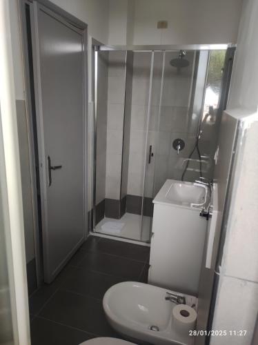 a bathroom with a shower and a toilet and a sink at Ostello Villa Monte Mario in Rome