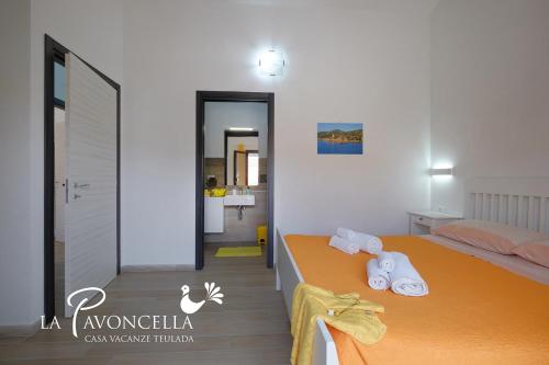 a bedroom with a bed with towels on it at Case Vacanze La Pavoncella in Teulada