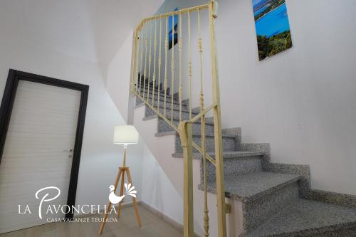 a stairway in a home with a stair railing at Case Vacanze La Pavoncella in Teulada