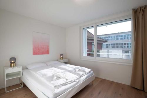 Cama o camas de una habitación en HITrental Letzigrund - Apartment