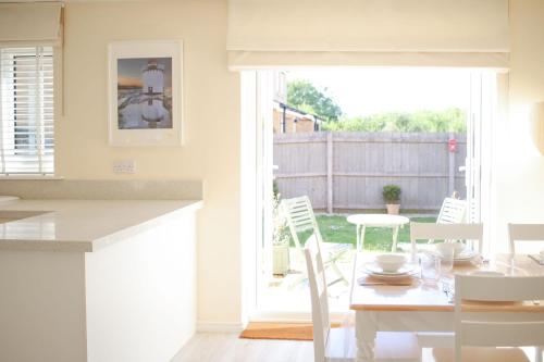 a kitchen and dining room with a table and chairs at Ffordd Y Meillion in Llanelli