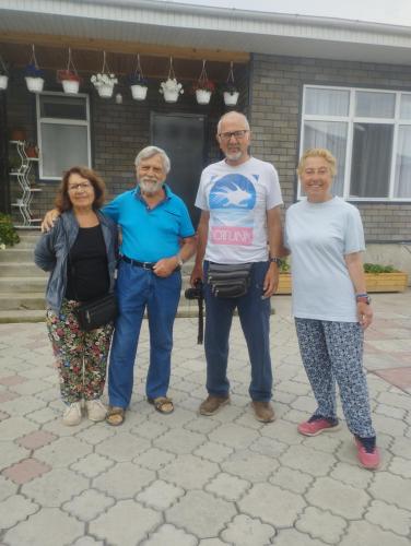 a group of people standing in front of a building at Guest house Roza in Kazarman