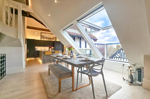 a kitchen and dining room with a table and chairs at Exclusive 3 Bedroom Penthouse - 2 Bath & Mezzanine in Harrogate