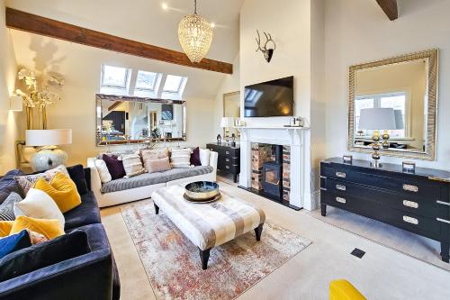 a living room with a couch and a fireplace at Exclusive 3 Bedroom Penthouse - 2 Bath & Mezzanine in Harrogate