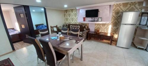a kitchen and a dining room with a table and chairs at Dream House & Hostel in Sevan