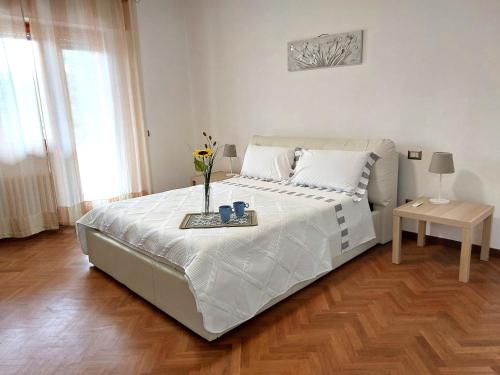a bedroom with a bed with a vase of flowers on it at Suite Sant'Anna in Greve in Chianti