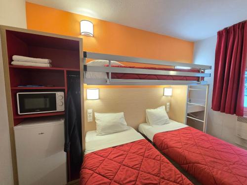a small room with two beds and a microwave at Premiere Classe Valence - Bourg Les Valence in Bourg-lès-Valence
