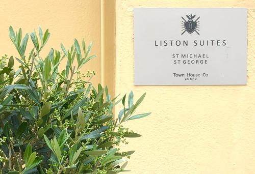 a sign on the side of a building with a plant at St. George Liston Suite in Corfu