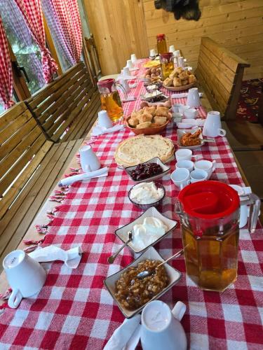 a long table with a red and white checkered table cloth at Eko Katun Hako in Dubočak
