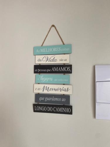 a group of signs hanging on a wall at Quarto Duplo Nova Mutum in Nova Mutum