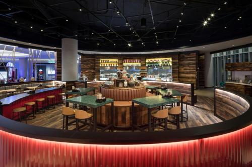 a restaurant with tables and chairs and a bar at JW Marriott Parq Vancouver in Vancouver