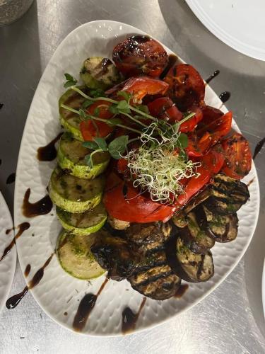a plate of food with vegetables on a table at Mayster Home in Chernivtsi