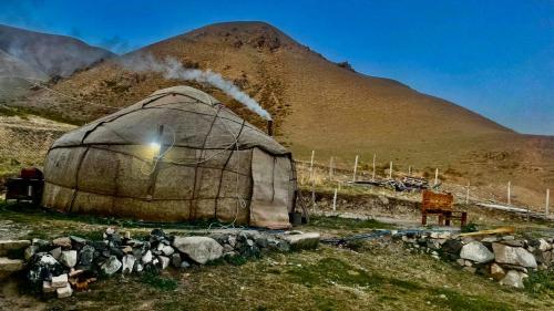 a large dome tent with a mountain in the background at Horse riding&Kyzart Homestay in Dzhangyaryk