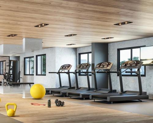 a gym with a row of treadles in a room at Tropical apartament in Sao Paulo