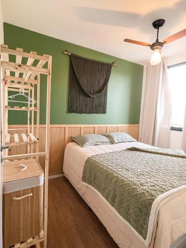 a bedroom with green walls and a bunk bed at Tropical apartament in São Paulo