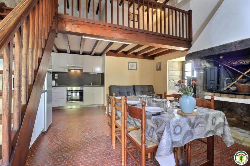 une salle à manger avec une table et une cuisine dans l'établissement Gîte de Bathernay au Donjon, à Bathernay