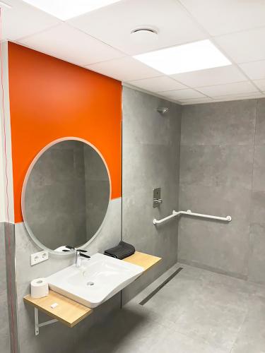 a bathroom with a sink and a mirror at Erlebniswelt Resort Apartment 5 in Reken
