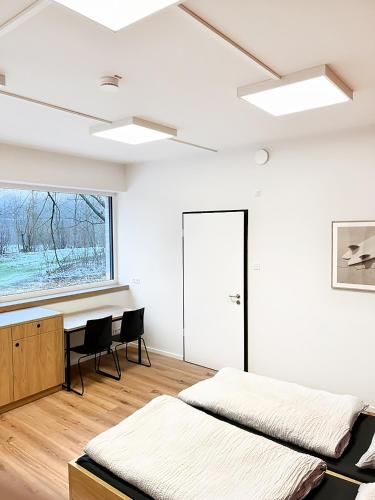 two beds in a room with a desk and a window at Erlebniswelt Resort Apartment 5 in Reken