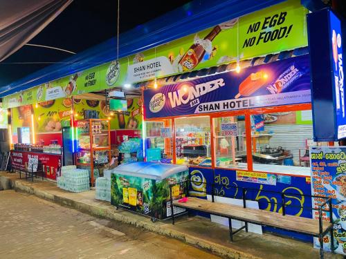 a fast food restaurant with a food court at night at Shan Hotel in Adams Peak