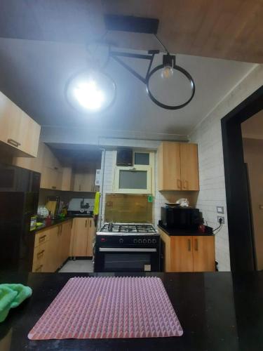 a kitchen with a pink mat on a table at Private lovely room with ac in Cairo