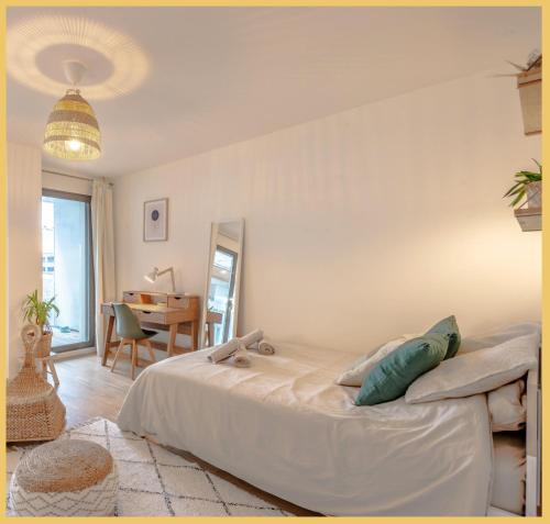 a bedroom with a large bed and a table at Chez Mike I Studio I Annemasse in Annemasse