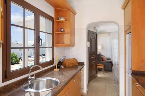 a kitchen with a sink and a window at Casa Calma in Playa Blanca