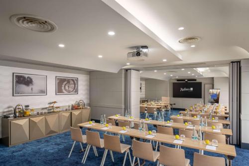 a conference room with a long table and chairs at Radisson Blu Hotel Bucharest in Bucharest