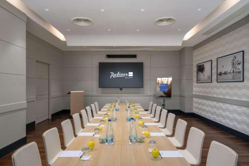 a conference room with a long table and chairs at Radisson Blu Hotel Bucharest in Bucharest