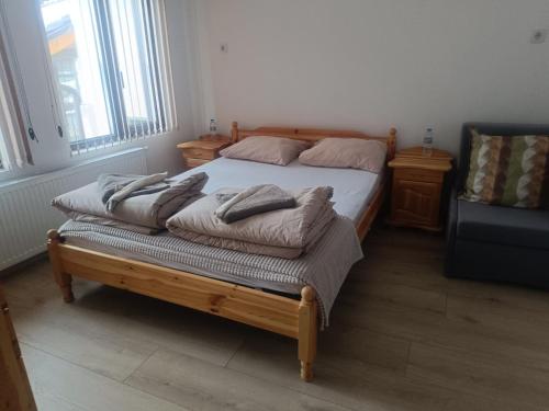 a bedroom with a bed with pillows on it at Guest Rooms Didka in Koprivshtitsa