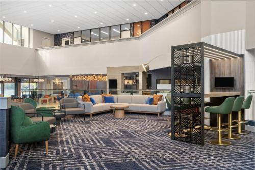a lobby of a hotel with couches and chairs at Crowne Plaza Virginia Beach Town Center by IHG in Virginia Beach
