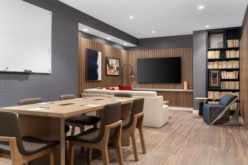 a conference room with a table and a couch at Crowne Plaza Virginia Beach Town Center by IHG in Virginia Beach