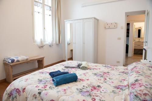 a bedroom with a bed with a floral bedspread at Historic center Teatro Regio appartamento Luca in Parma