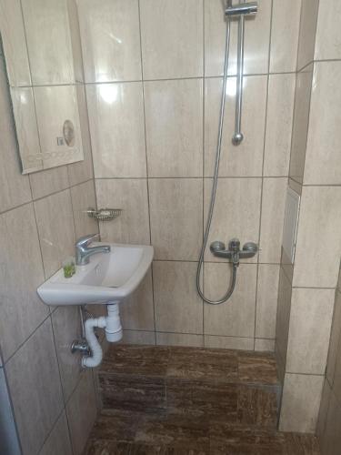 a bathroom with a sink and a shower at Guest Rooms Didka in Koprivshtitsa