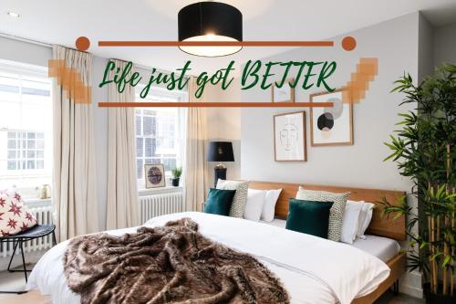 a bedroom with a bed with a sign that reads life just get better at 1st Class Covent Garden Residences for 1st Class Guests in London