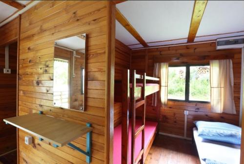 a wooden cabin with a bunk bed and a ladder at RS U Kapličky in Jindřichŭv Hradec