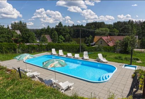 a swimming pool with a bunch of chairs around it at RS U Kapličky in Jindřichŭv Hradec