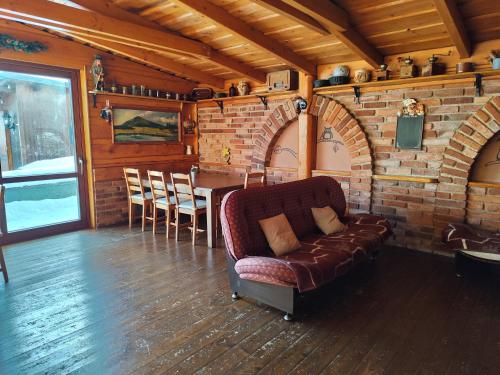 a living room with a couch and a table at Ubytování U Bohouše in Jilemnice