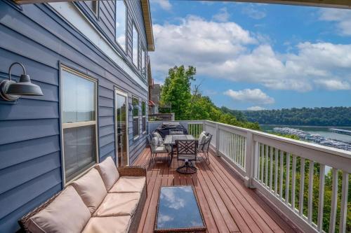 a balcony with a couch and a table and chairs at Harborview at Lake Cumberland in Somerset
