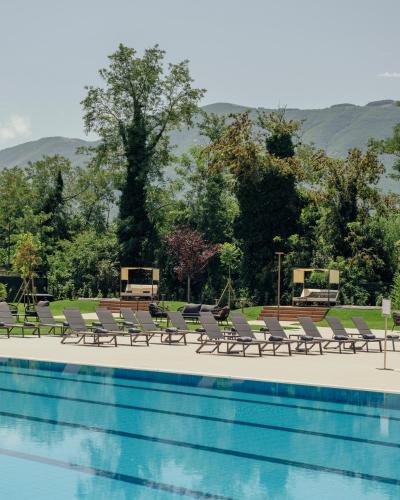 a pool with chaise lounge chairs and a swimming pool at Grand Hotel Telese in Telese