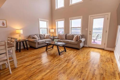 a living room with two couches and a table at Harborview at Lake Cumberland in Somerset